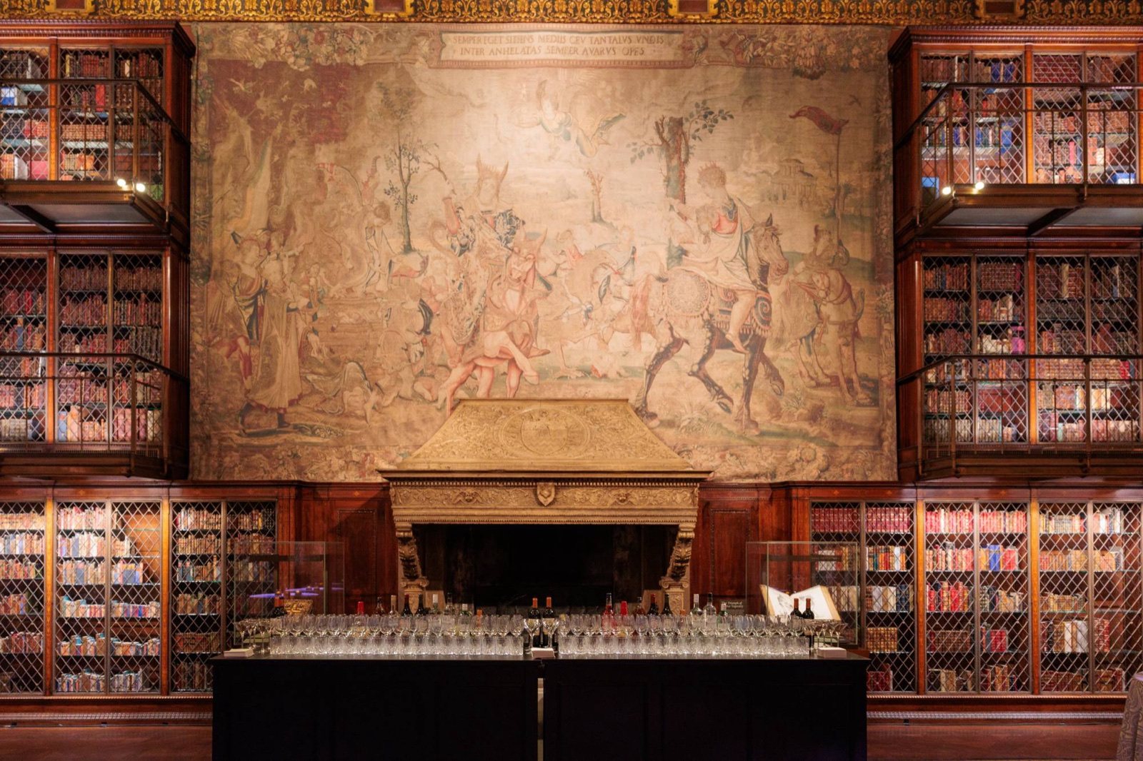 The historic library bar, set beneath the tapestry and fireplace