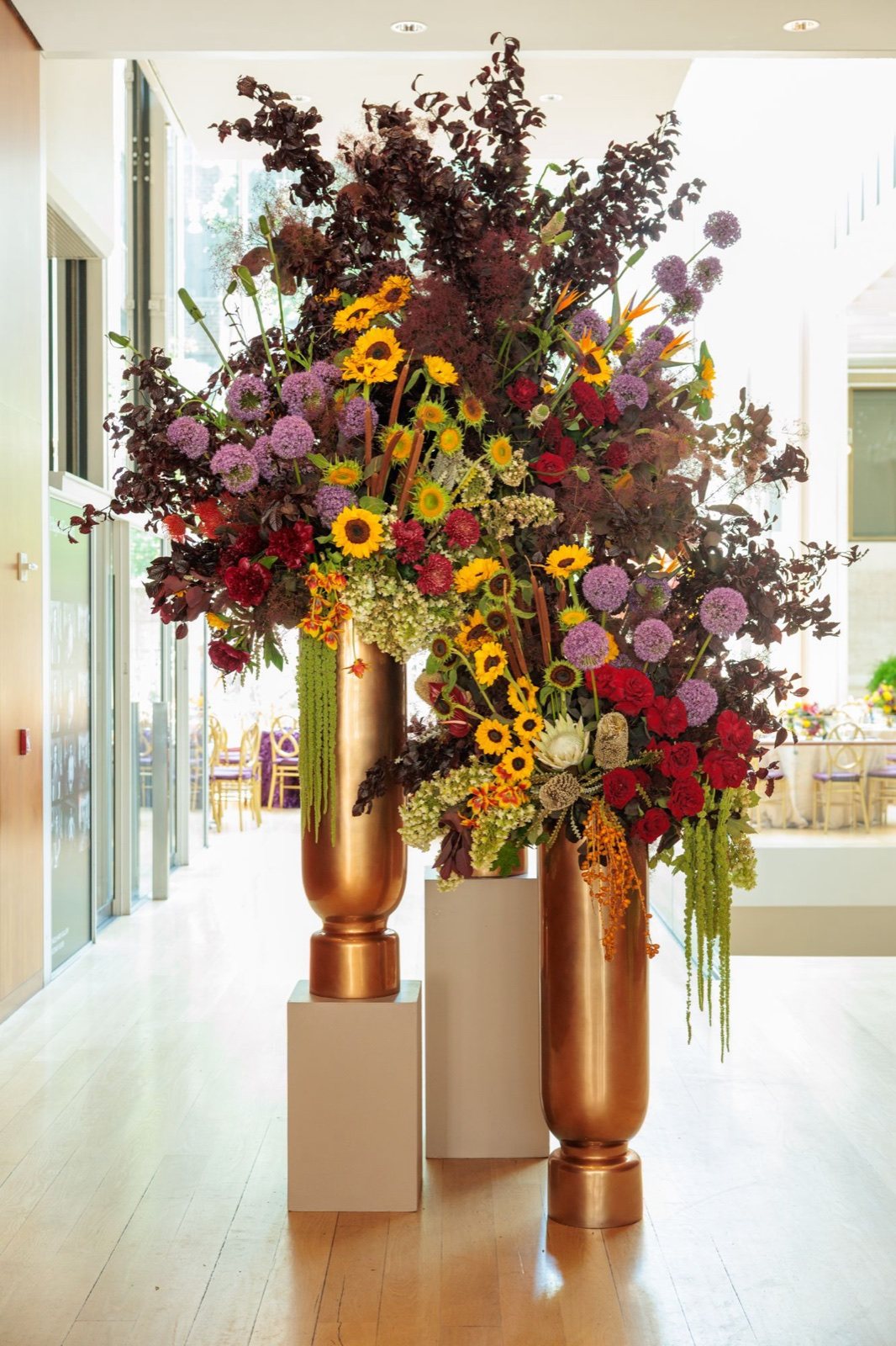 A towering floral arrangement in bronze vases
