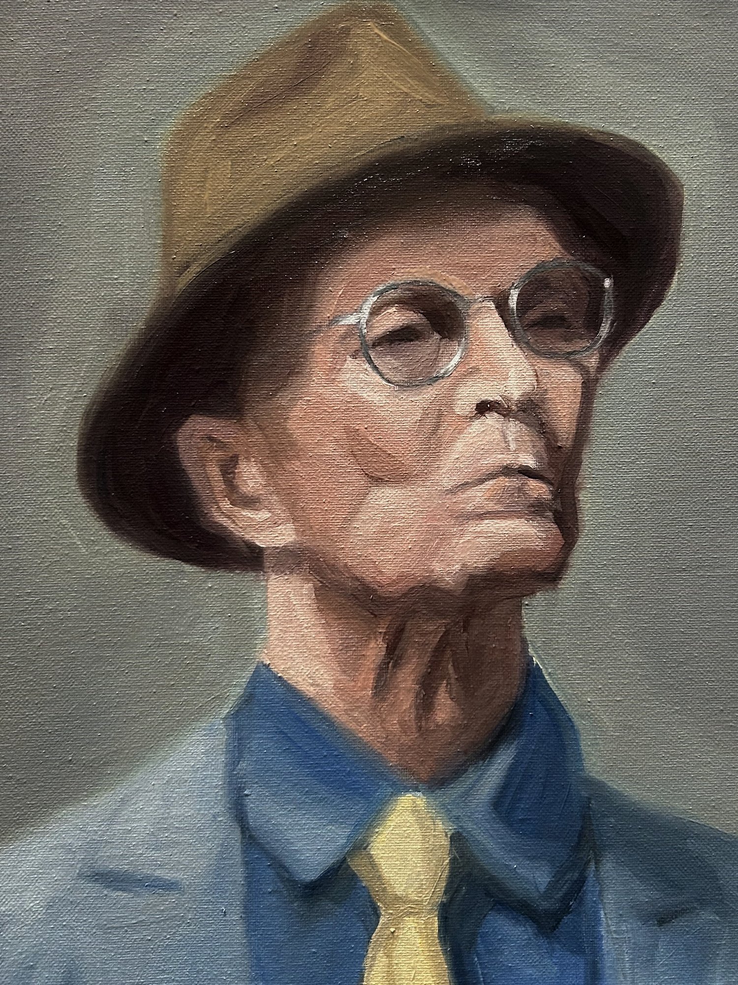 Oil portrait of an older man in a brown hat and round glasses, with a blue shirt and yellow tie
